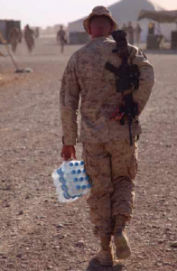 A U.S. Marine carries water back to his tent in Afghanistan. Maintaining critical supplies of water in the field consumes fuel and risks lives. Source: DoD Photo by Lance Cpl Phillip Elgie, U.S. Marine Corps