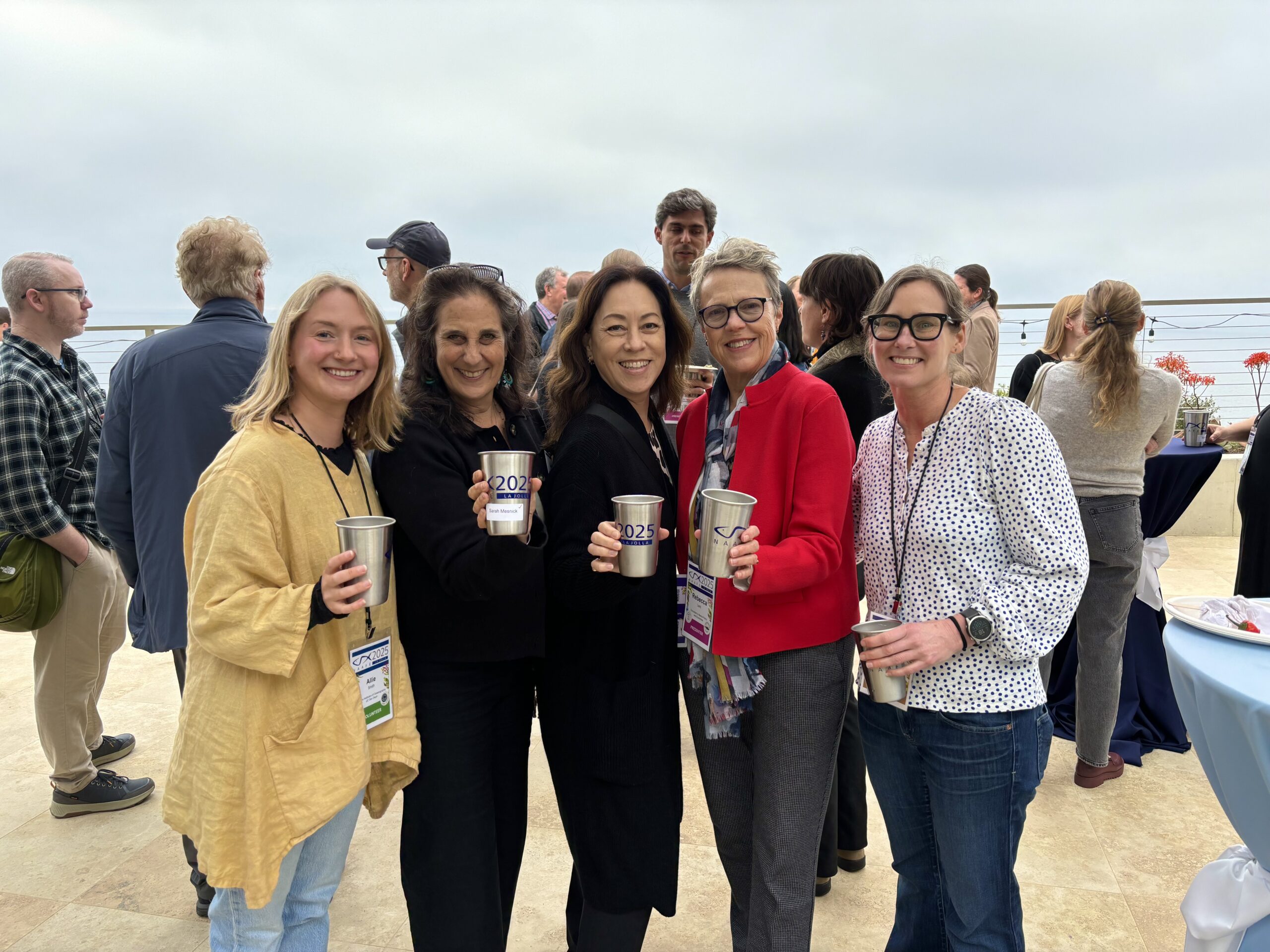 Organizers and volunteers pose for a group photo on MCTF's Page Pavilion with their NAAFE cups in hand.