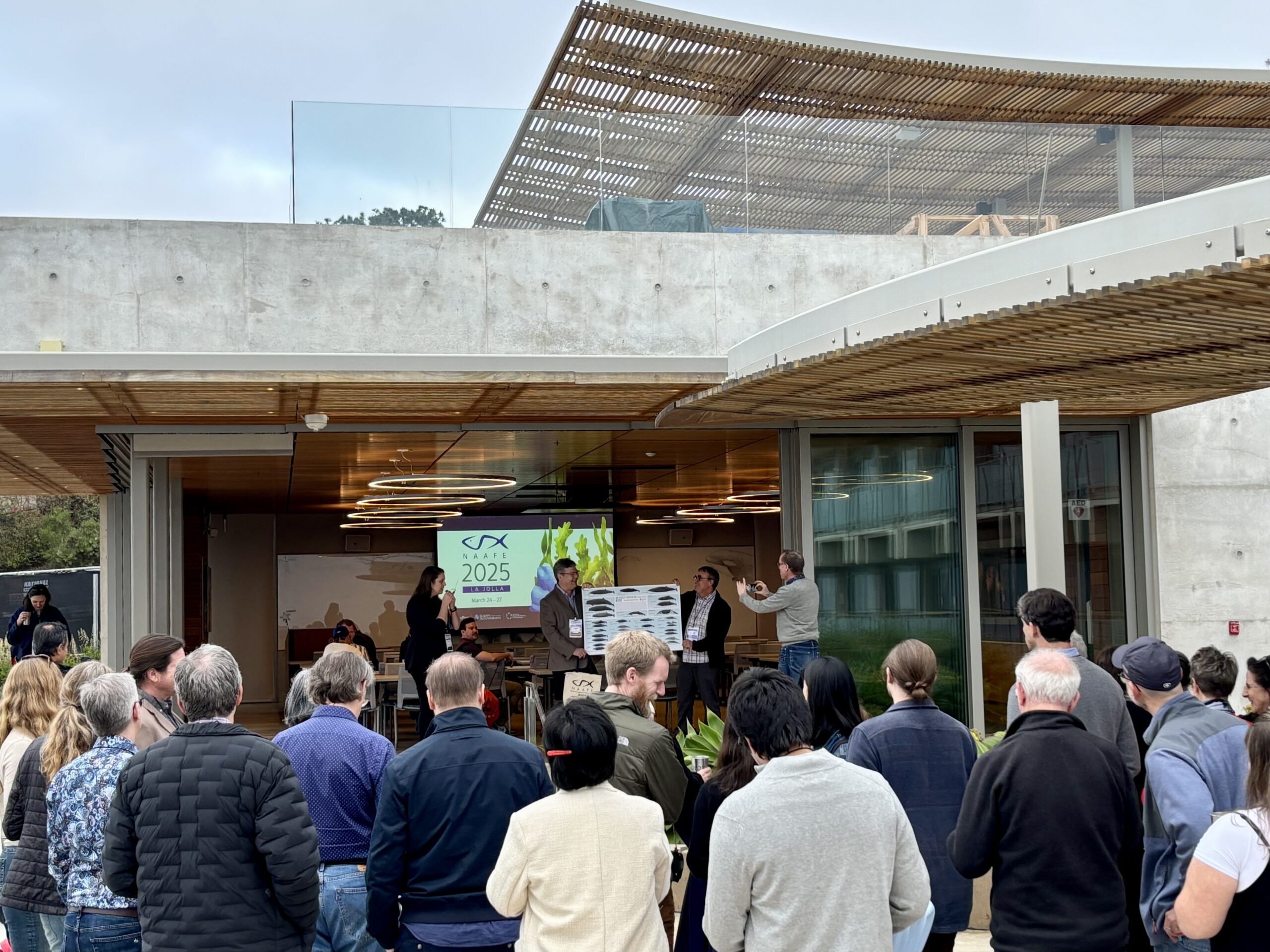 Group of guests gather on the outdoor Page Pavillion patio at MCTF.