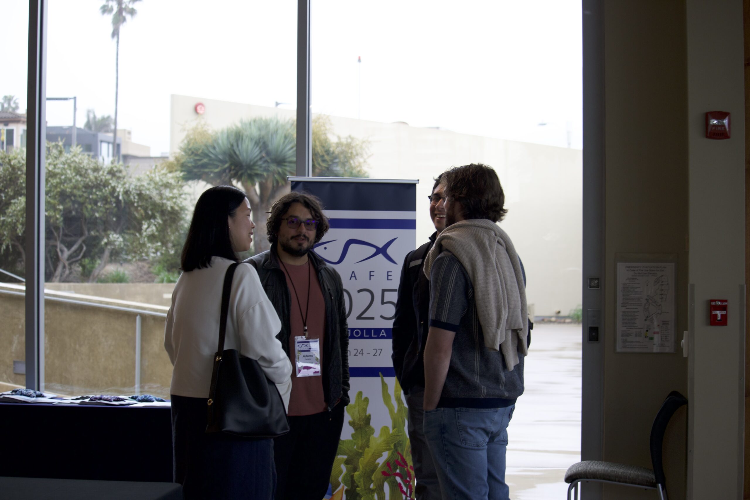 Attendees network with one another during a coffee break in the Seaside Forum Lobby.